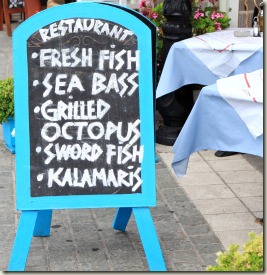 Menu board outside of a fish restaurant in Greece